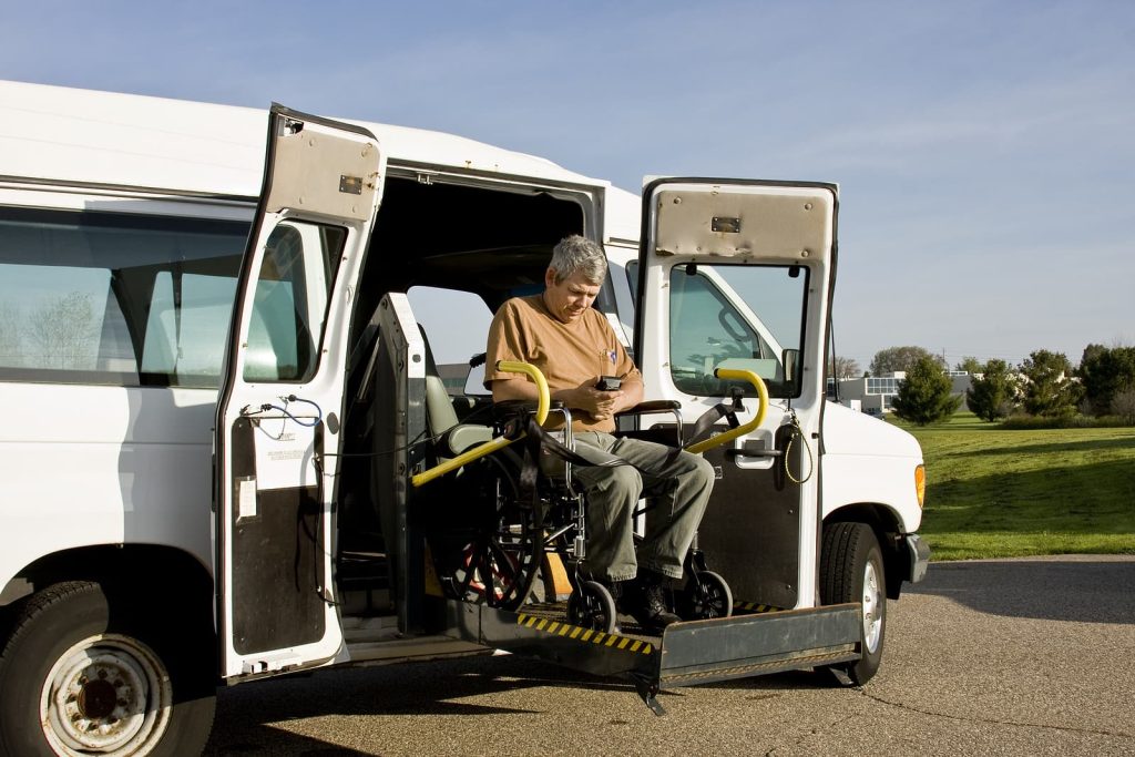 Wheelchair lift installation - man operating a wheelchair lift van
